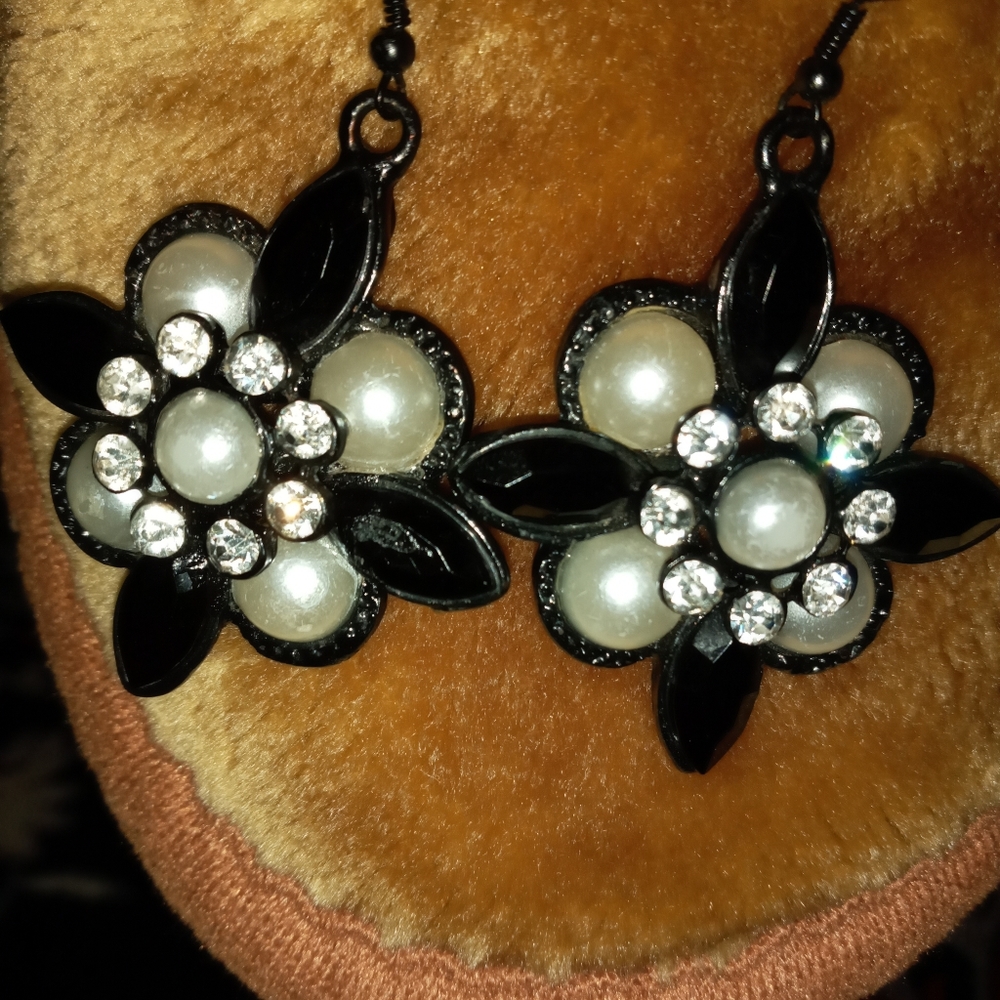 Black hard rock earrings with diamonds and pearls.